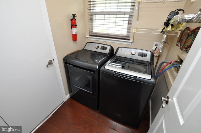 laundry room with baseboards, laundry area, dark wood-style flooring, and washing machine and clothes dryer