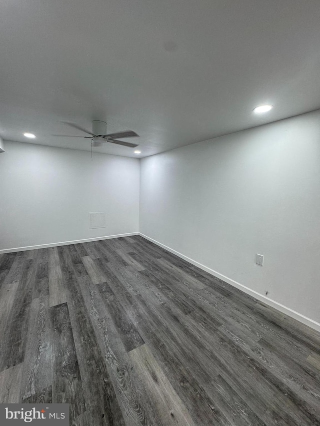 empty room featuring a ceiling fan, dark wood-type flooring, recessed lighting, and baseboards