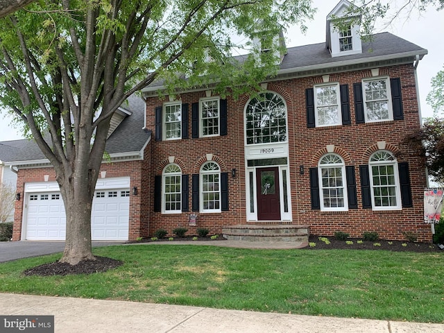 19009 Old Baltimore Rd, Brookeville, MD 20833 - colonial home with an attached garage, driveway, a front lawn, and brick siding