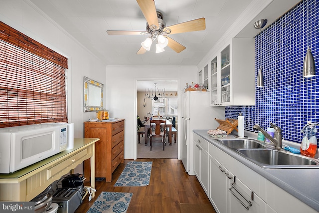 12506 Assawoman Dr, Ocean City, MD 21842 - kitchen featuring a ceiling fan, white appliances, a sink, glass insert cabinets, and dark wood-style flooring