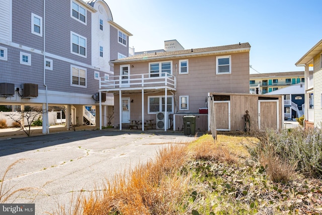 12506 Assawoman Dr, Ocean City, MD 21842 - rear view of property featuring stairway and central air condition unit