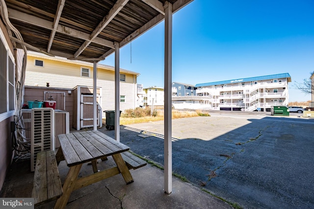 12506 Assawoman Dr, Ocean City, MD 21842 - view of patio / terrace with an outdoor structure, a residential view, and a shed