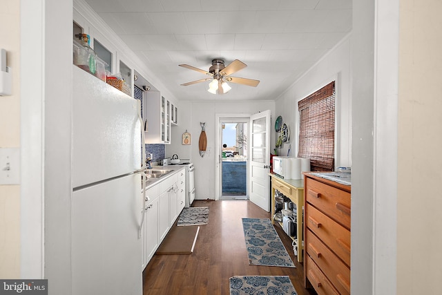 12506 Assawoman Dr, Ocean City, MD 21842 - kitchen with dark wood-style flooring, white cabinetry, glass insert cabinets, a ceiling fan, and white appliances