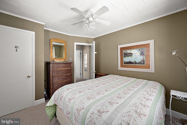 12506 Assawoman Dr, Ocean City, MD 21842 - bedroom featuring ceiling fan, a decorative wall, ornamental molding, and carpet