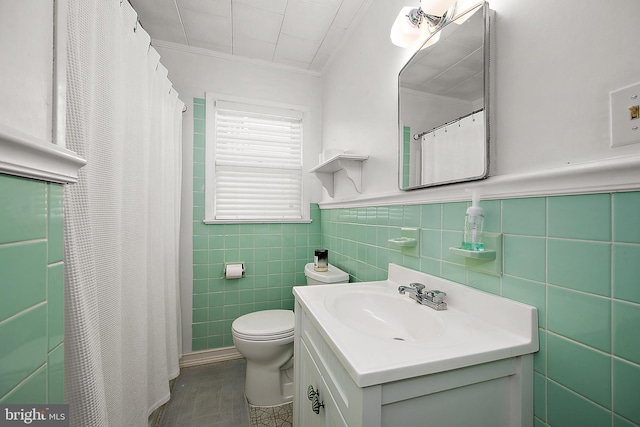 12506 Assawoman Dr, Ocean City, MD 21842 - bathroom featuring vanity, tile walls, a wainscoted wall, toilet, and ornamental molding