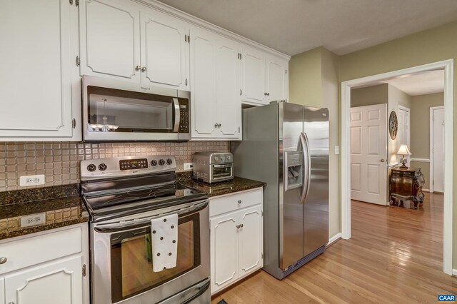 4045 Buck Island Rd, Charlottesville, VA 22902 - kitchen featuring light wood-style flooring, backsplash, white cabinetry, and appliances with stainless steel finishes