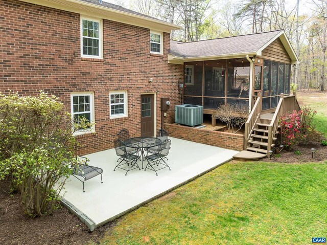 4045 Buck Island Rd, Charlottesville, VA 22902 - back of house featuring a patio area, a sunroom, a yard, and central AC unit