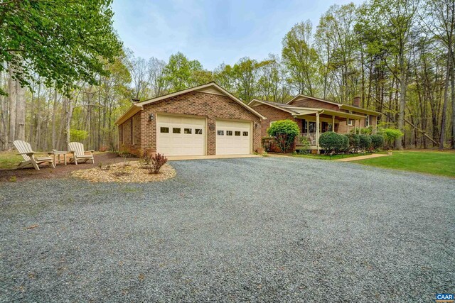 4045 Buck Island Rd, Charlottesville, VA 22902 - ranch-style home with covered porch, a chimney, brick siding, and a garage