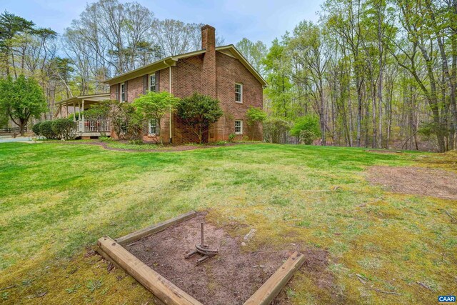 4045 Buck Island Rd, Charlottesville, VA 22902 - view of side of home with brick siding, a yard, a garden, and a chimney
