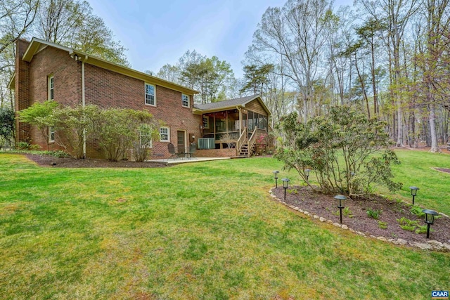 4045 Buck Island Rd, Charlottesville, VA 22902 - back of property featuring brick siding, a sunroom, central air condition unit, and a lawn