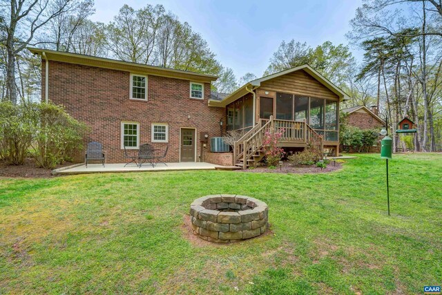 4045 Buck Island Rd, Charlottesville, VA 22902 - rear view of property with brick siding, a patio, a lawn, an outdoor fire pit, and a sunroom