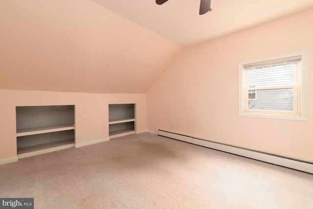 bonus room with a baseboard radiator, a ceiling fan, baseboards, lofted ceiling, and carpet flooring
