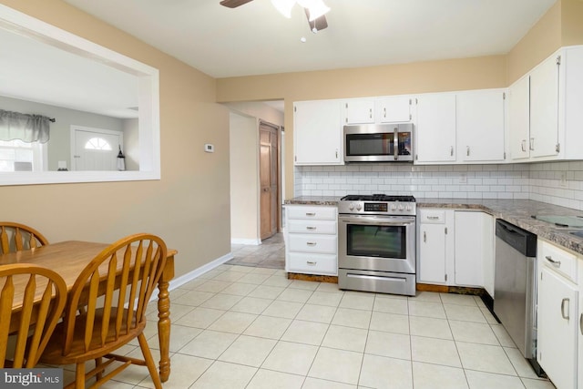kitchen with appliances with stainless steel finishes, tasteful backsplash, and white cabinetry