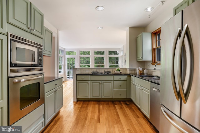 6218 30th St NW, Washington, DC 20015 - kitchen featuring appliances with stainless steel finishes, a sink, dark countertops, a peninsula, and recessed lighting