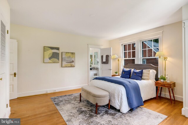 6218 30th St NW, Washington, DC 20015 - bedroom with light wood-type flooring, baseboards, and connected bathroom