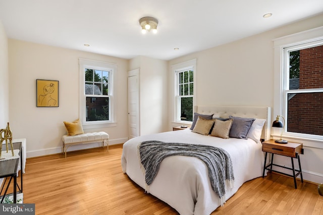 6218 30th St NW, Washington, DC 20015 - bedroom with light wood-style flooring, multiple windows, and baseboards