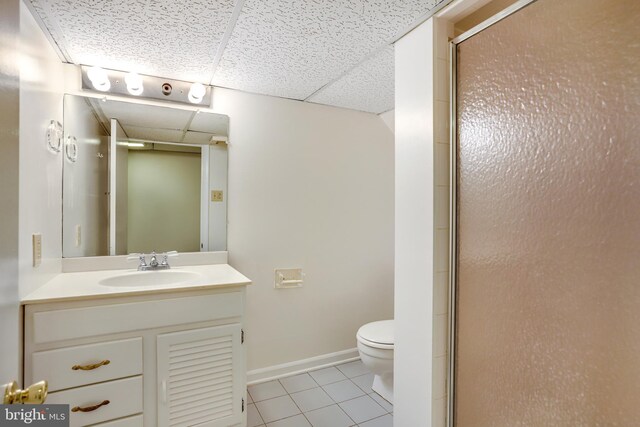 6218 30th St NW, Washington, DC 20015 - full bathroom with a drop ceiling, tile patterned floors, toilet, a shower with door, and vanity