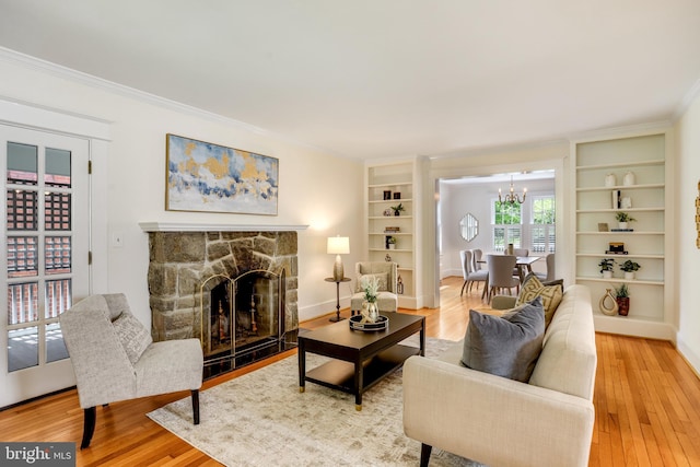 6218 30th St NW, Washington, DC 20015 - living room with built in shelves, light wood-type flooring, a chandelier, and ornamental molding