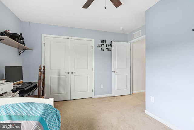 carpeted bedroom featuring a closet, visible vents, ceiling fan, and baseboards
