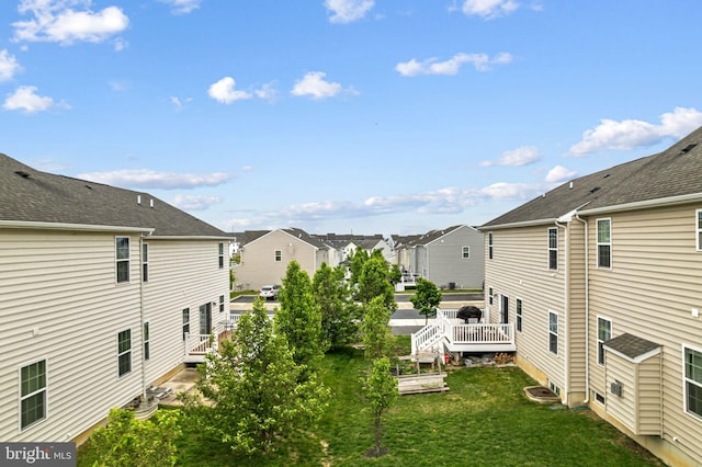 exterior space featuring a wooden deck and a residential view