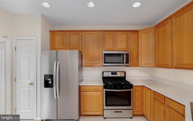 kitchen featuring light countertops, recessed lighting, and appliances with stainless steel finishes