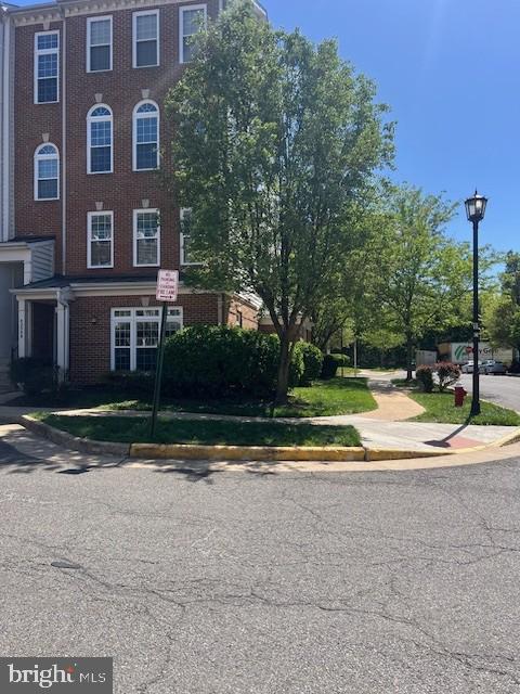 townhome / multi-family property with brick siding