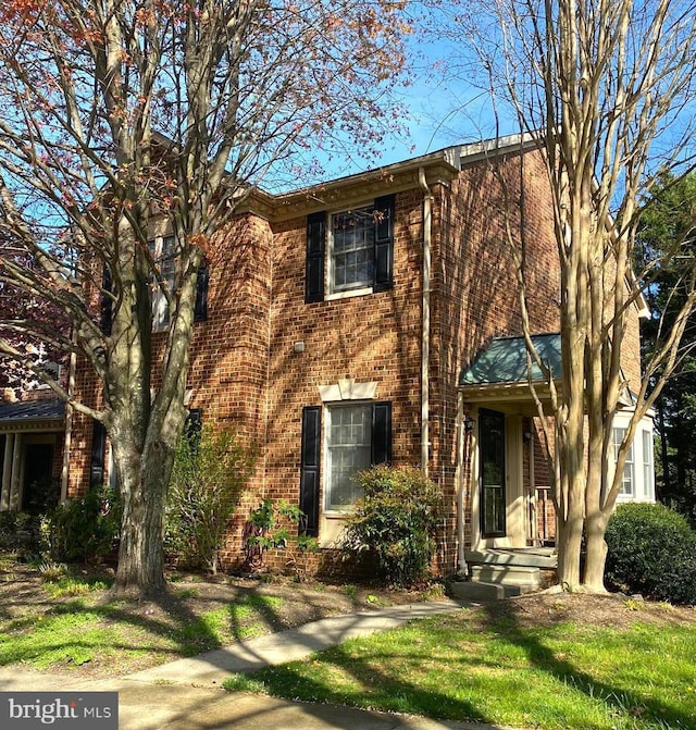 view of front of home featuring brick siding