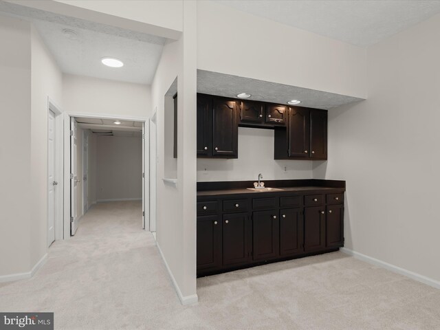 2828 Quarry Heights Way, Baltimore, MD 21209 - kitchen featuring light colored carpet, baseboards, dark countertops, and a sink