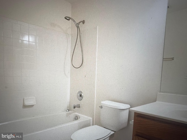 bathroom with vanity, washtub / shower combination, and toilet