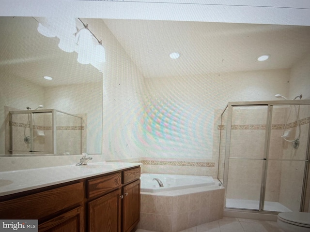 full bath with a garden tub, a sink, double vanity, and a stall shower
