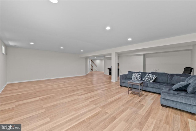 living area featuring stairway, recessed lighting, baseboards, and light wood-type flooring