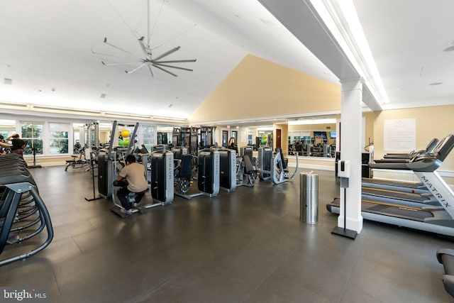 exercise room with ornate columns and lofted ceiling