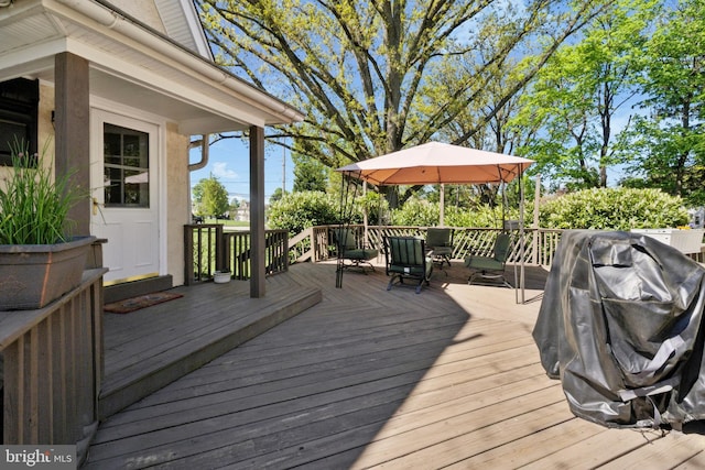 wooden deck with a grill