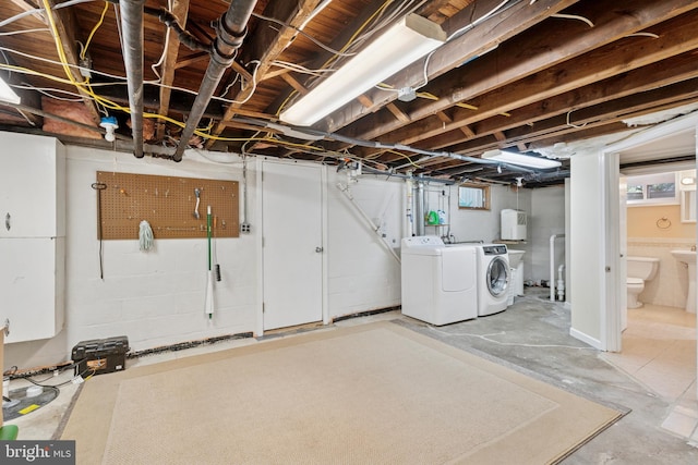 basement featuring washing machine and clothes dryer