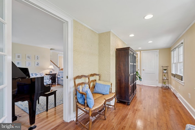 sitting room with stairway, ornamental molding, recessed lighting, and light wood-style flooring