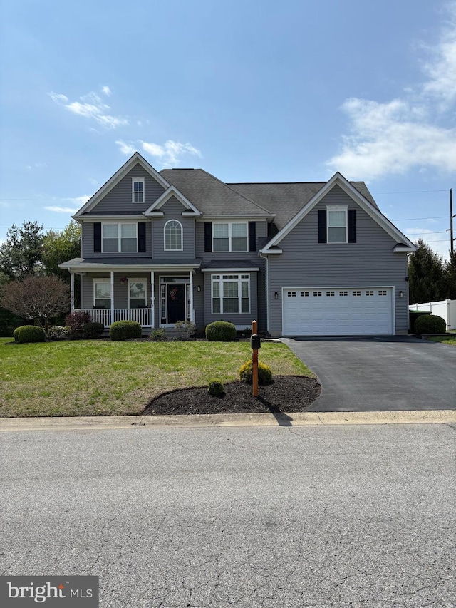 362 Hoffeckers Mill Dr, Smyrna, DE 19977 - view of front of house featuring an attached garage, driveway, a front yard, and covered porch