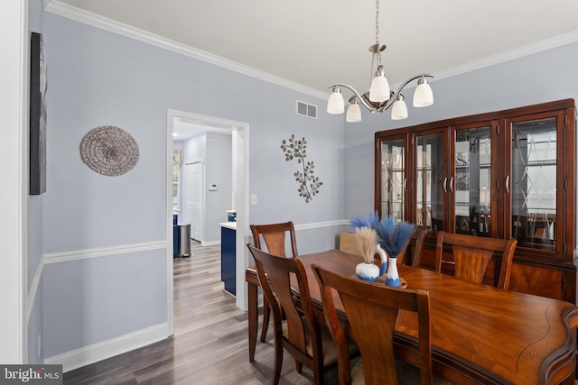 362 Hoffeckers Mill Dr, Smyrna, DE 19977 - dining area with a chandelier, crown molding, wood finished floors, and baseboards