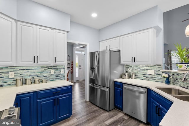 362 Hoffeckers Mill Dr, Smyrna, DE 19977 - kitchen featuring stainless steel appliances, a sink, blue cabinets, dark wood finished floors, and white cabinetry