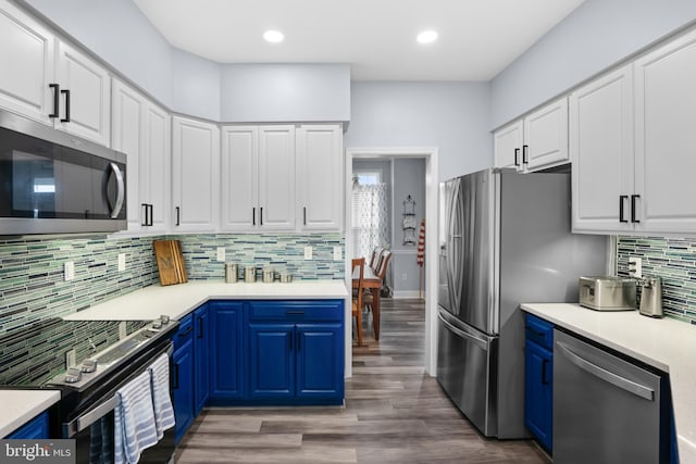 362 Hoffeckers Mill Dr, Smyrna, DE 19977 - kitchen featuring stainless steel appliances, blue cabinets, decorative backsplash, white cabinetry, and light countertops