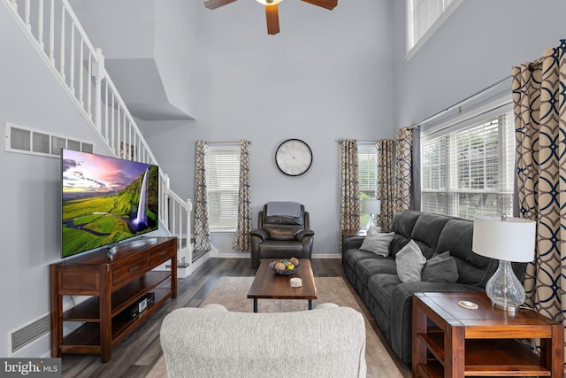 362 Hoffeckers Mill Dr, Smyrna, DE 19977 - living room featuring a high ceiling, stairway, ceiling fan, wood finished floors, and baseboards