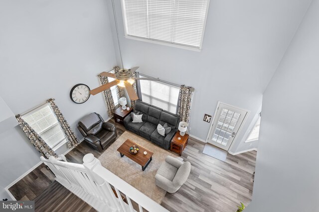 362 Hoffeckers Mill Dr, Smyrna, DE 19977 - living room featuring a towering ceiling, a ceiling fan, wood finished floors, and baseboards