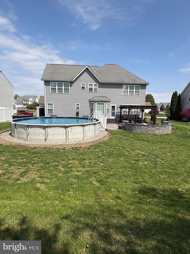 362 Hoffeckers Mill Dr, Smyrna, DE 19977 - rear view of house with an outdoor pool, a lawn, and central AC unit