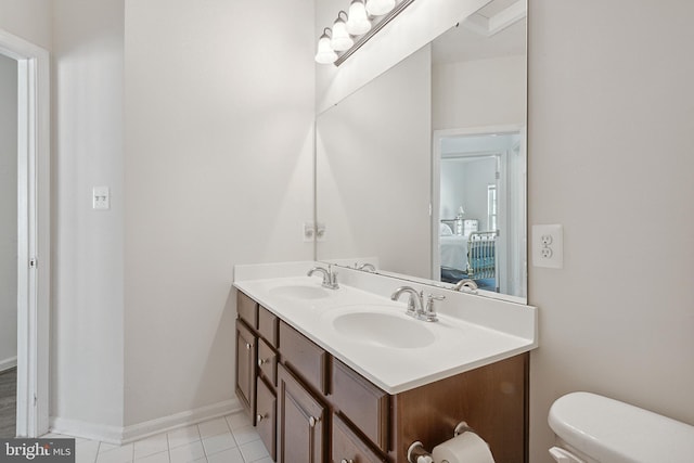 bathroom featuring a sink, toilet, double vanity, and connected bathroom