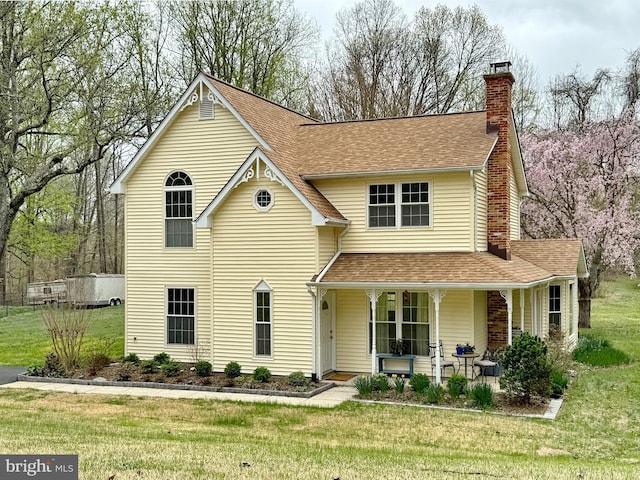 260 Sun Park Ln, Huntingtown, MD 20639 - traditional-style home with covered porch, a front yard, and a shingled roof
