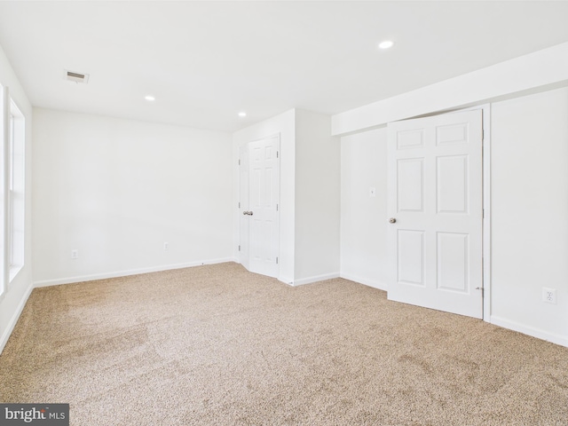 interior space with carpet floors, baseboards, visible vents, and recessed lighting