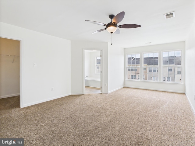 interior space featuring baseboards, a spacious closet, a closet, and carpet