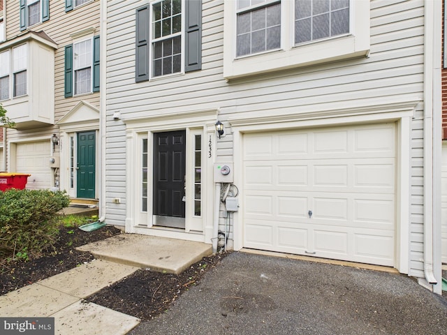 entrance to property featuring an attached garage