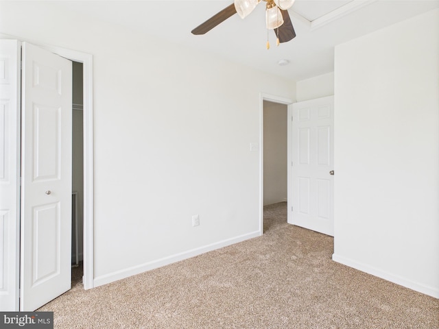 unfurnished bedroom with baseboards, ceiling fan, and light colored carpet