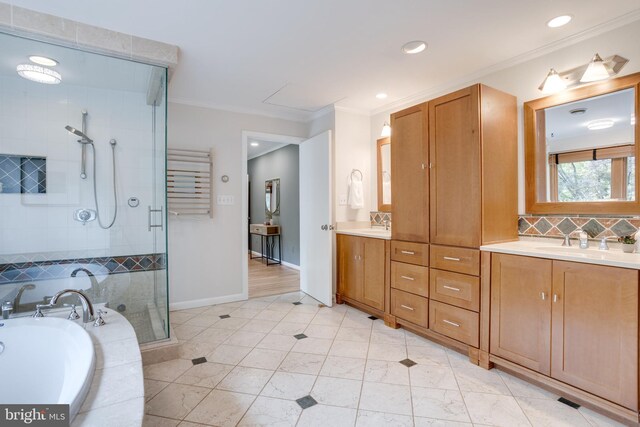 8604 Tobin Rd, Annandale, VA 22003 - full bathroom with ornamental molding, a shower stall, double vanity, a garden tub, and baseboards