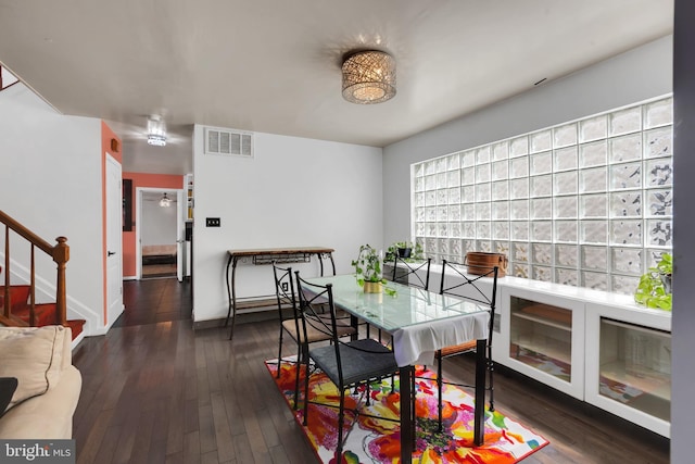 dining room with stairway, visible vents, dark wood finished floors, and baseboards